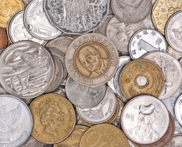 Coins currency from multiple countries, taken from top in isolated background view can be use for financial purposes